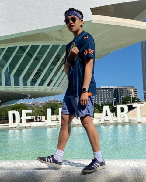 Photo of student Rebecca Brown walking alongside the pool on a sunny day at Berklee's Valencia campus.