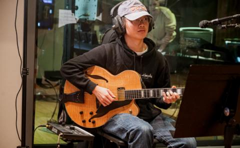 Guitarist recording at the AKSS recording stage of the Berklee Valencia campus.