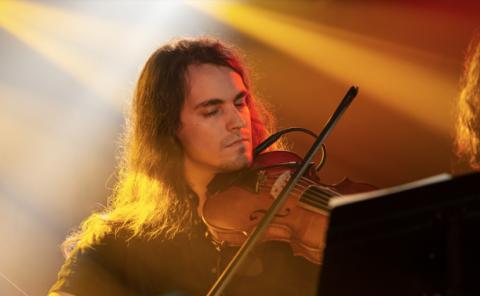 Violin student playing in a local venue in Valencia.