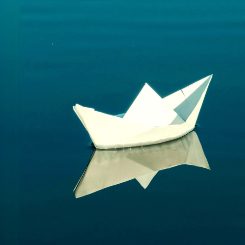 Image of the show featuring a paper boat 